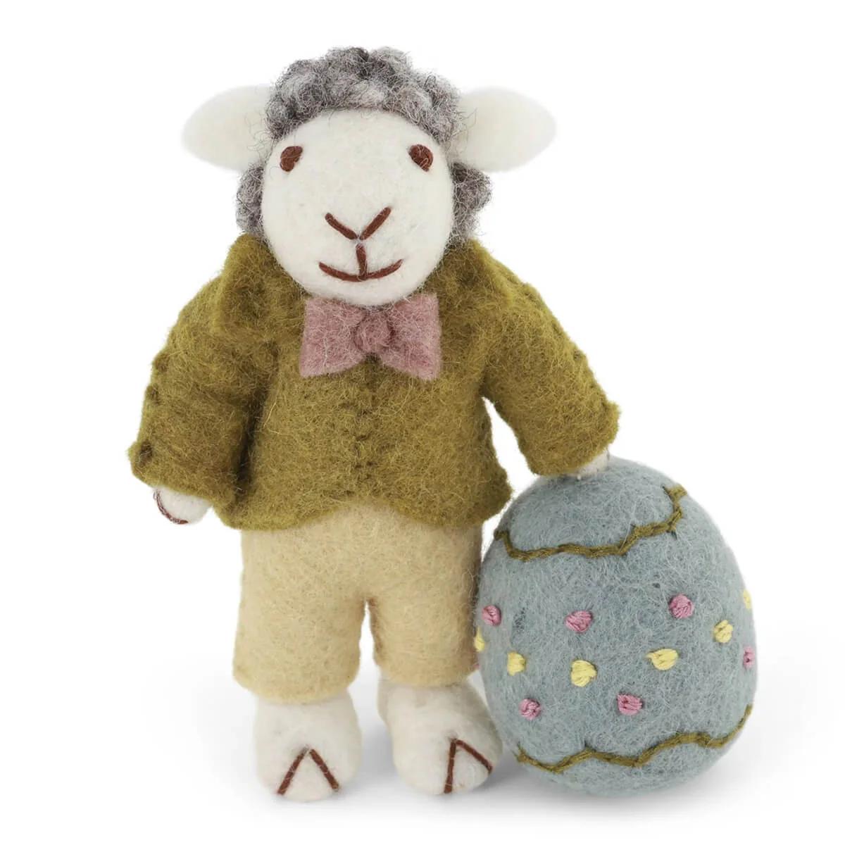 Plush sheep stuffed animal in dark green jacket with a large speckled egg at side
