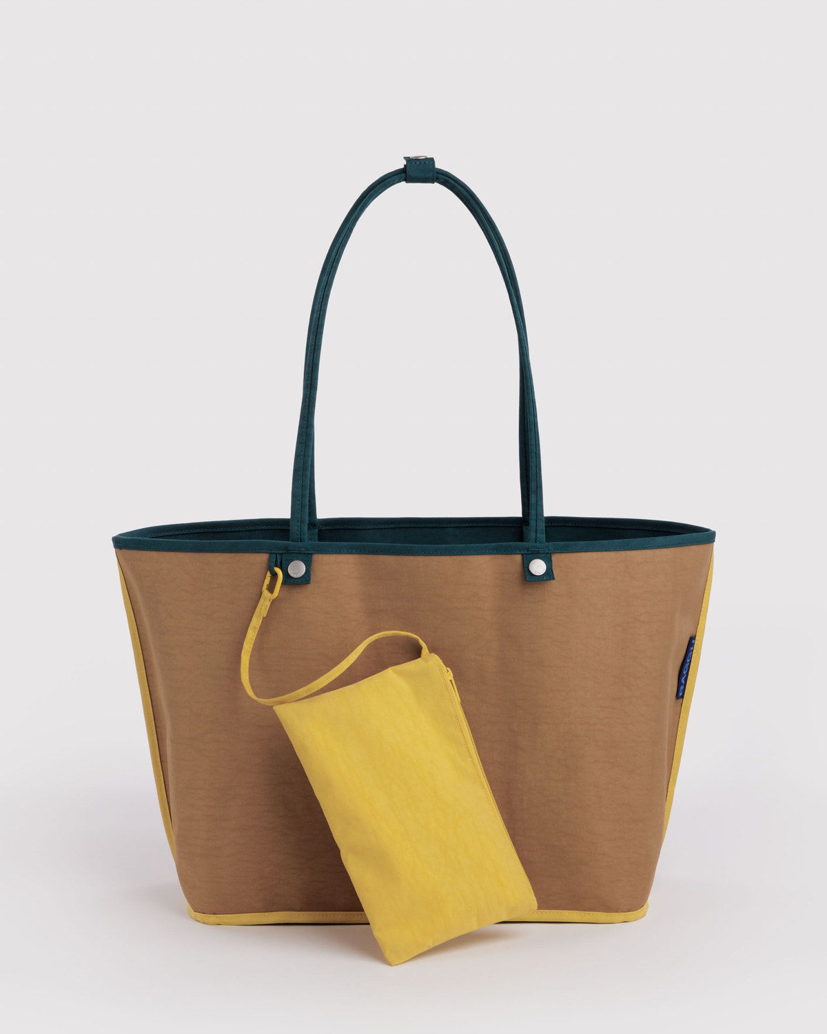 Large nylon reversible tote with tan exterior and yellow drawstring pouch