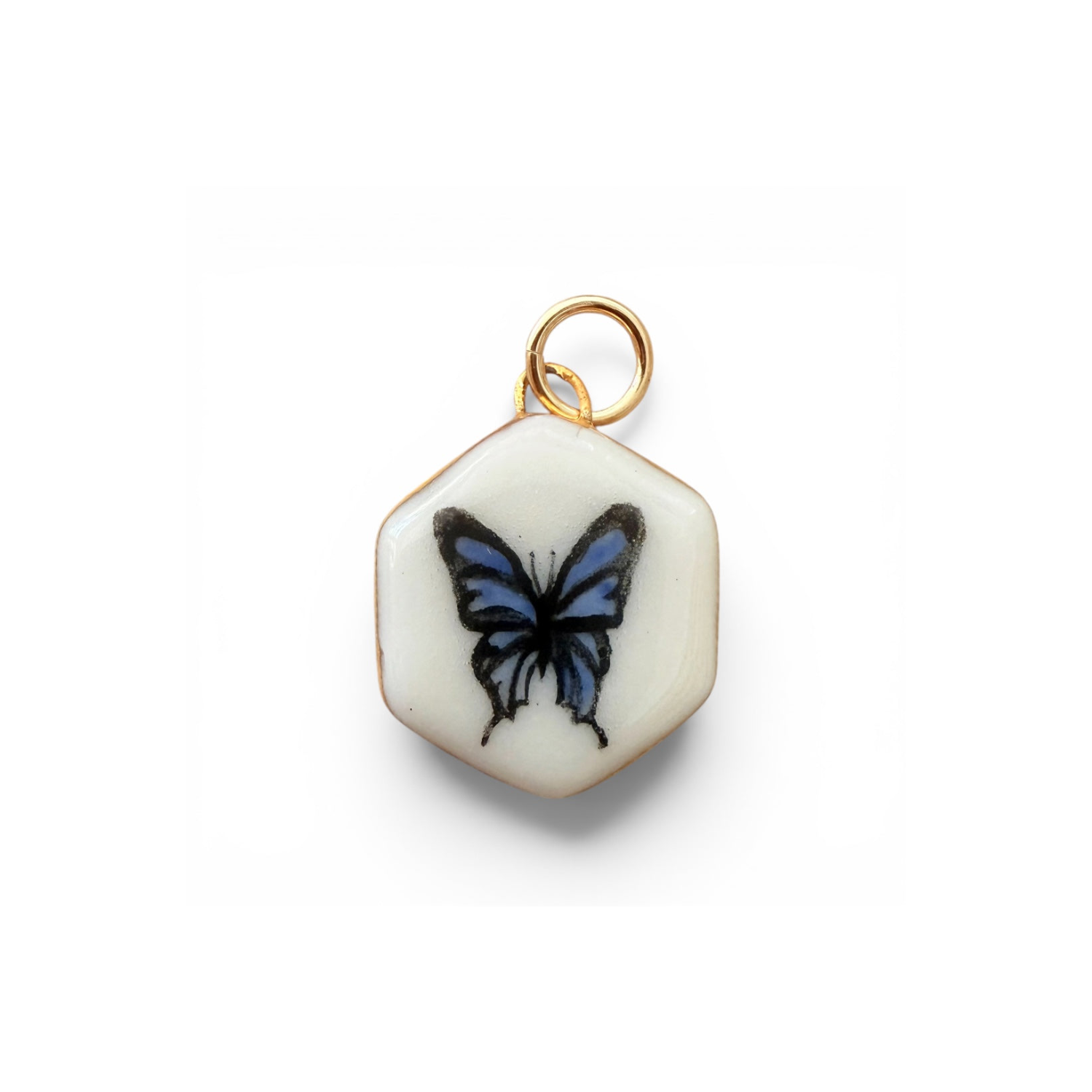 Porcelain hexagon charm with blue butterfly graphic and gold loop bail.