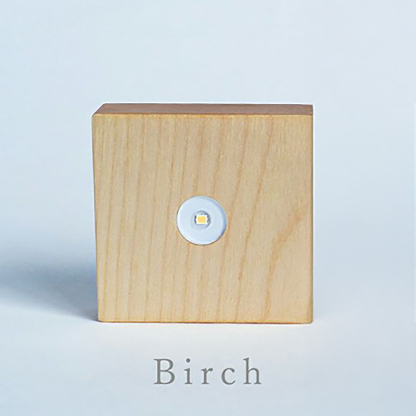 Birch wood cube light base with round LED button and clear top