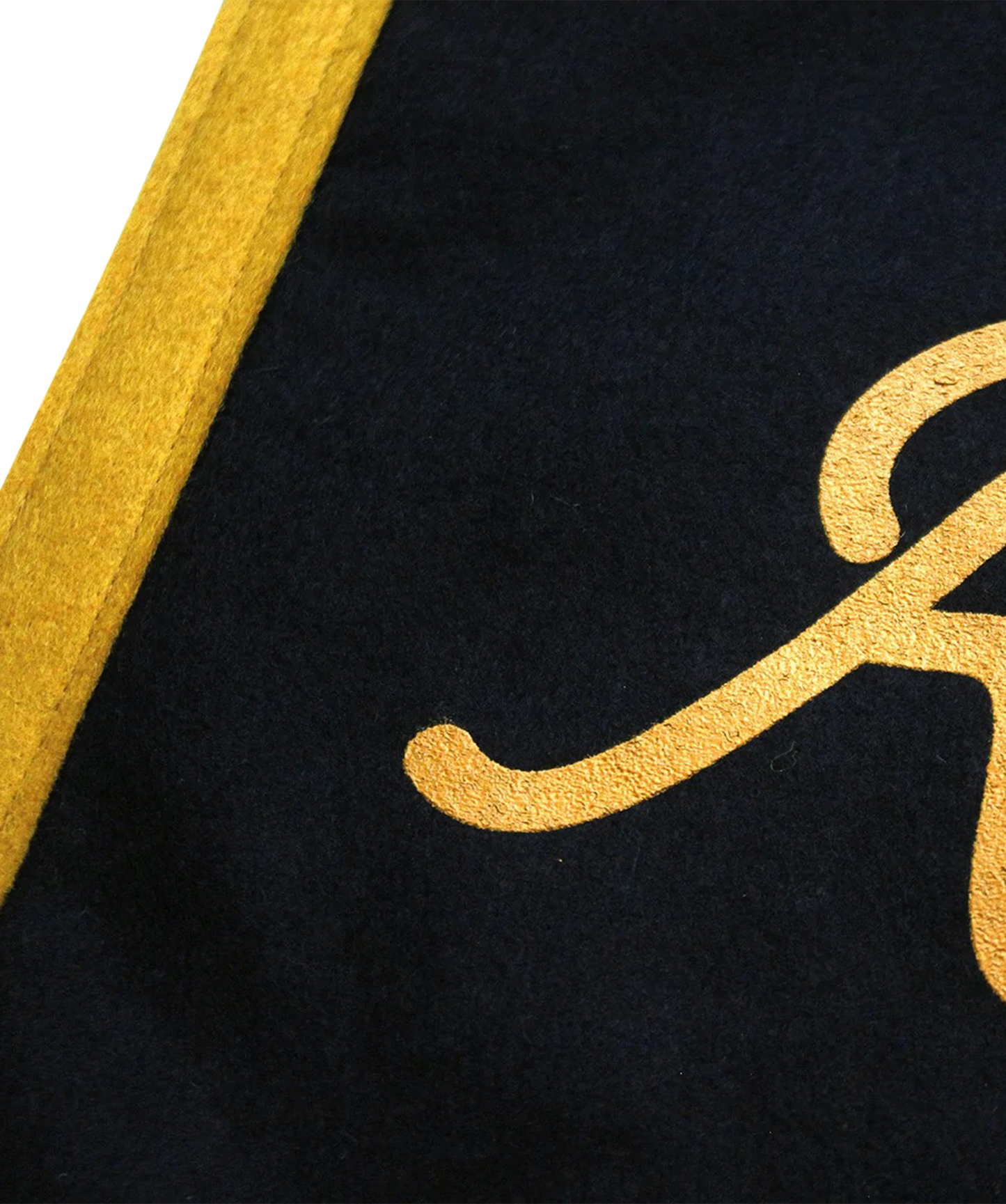 Close-up of black camp flag fabric with gold script lettering and yellow trim.