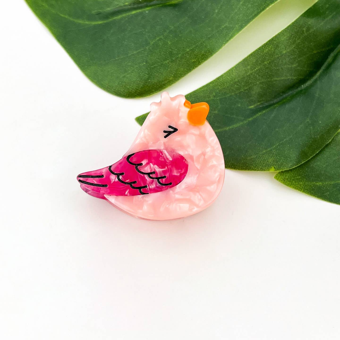 Light pink bird hair claw clip with orange crown and pink heart wing pattern