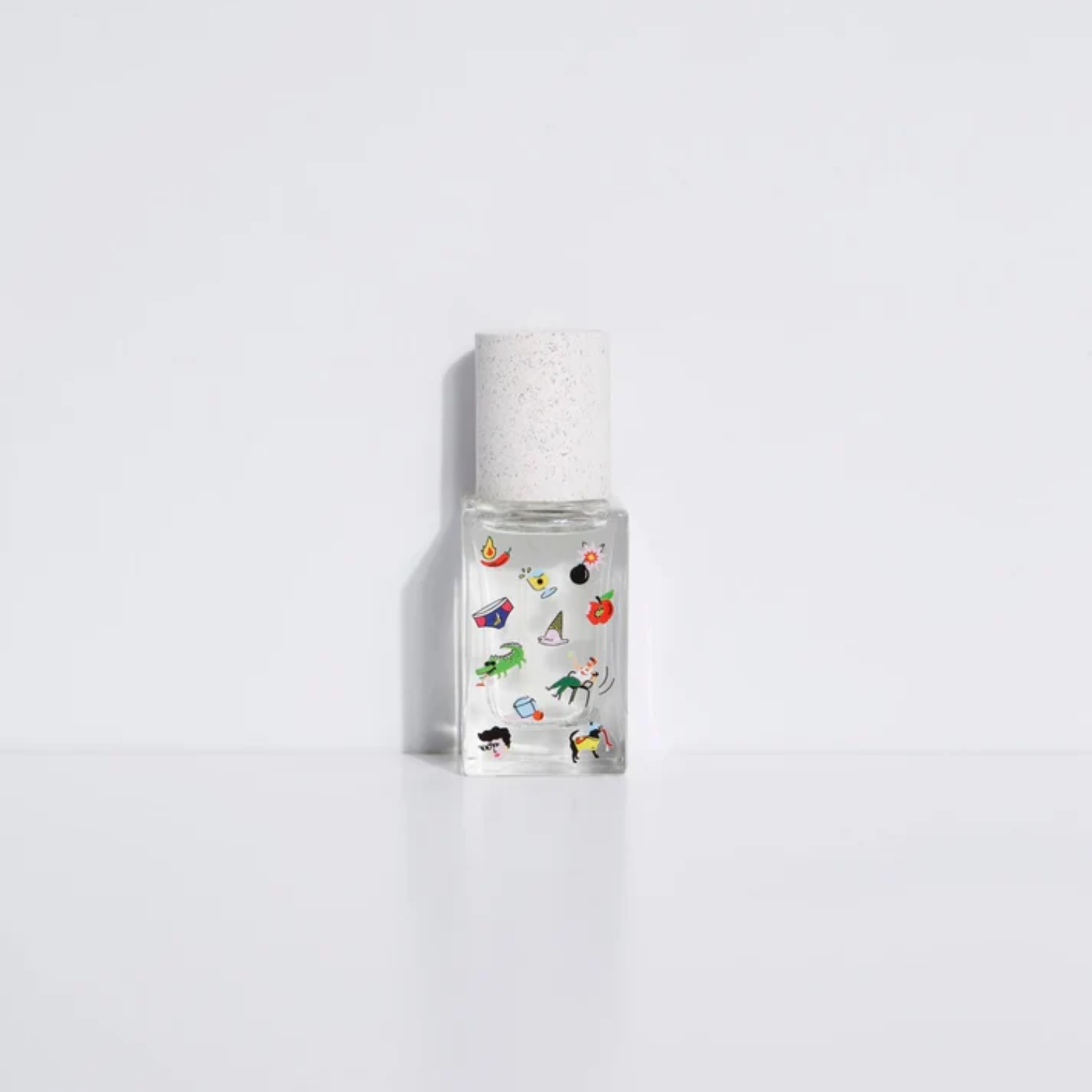 Poom Poom eau de parfum bottle, clear with colorful cartoon print and silver cap