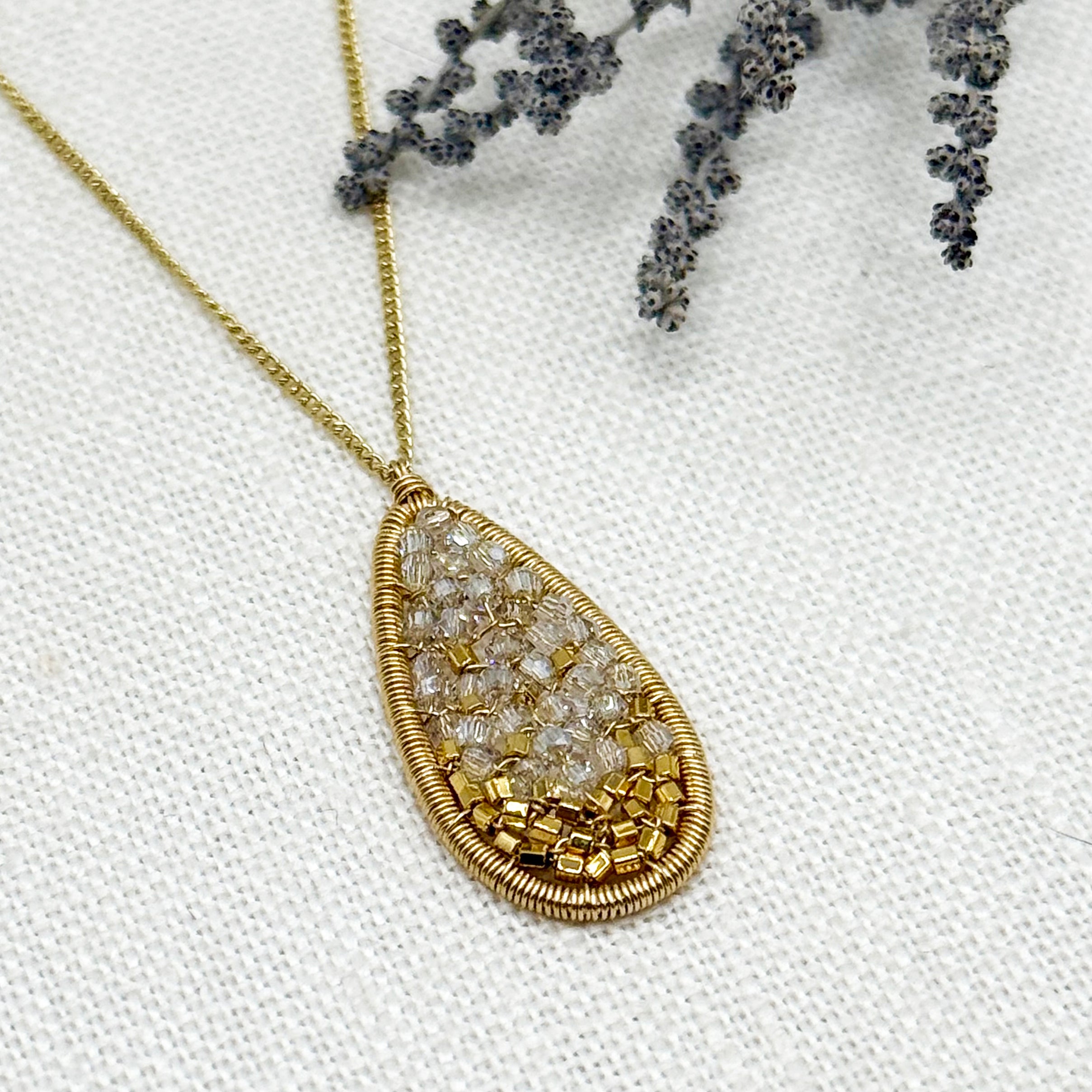 Long oval crystal mosaic pendant with gold beaded frame and chain