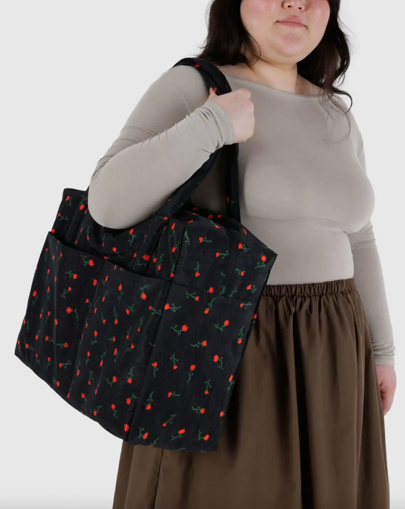 Cherry print carry-on travel bag in black with red-and-green pattern and short handles.