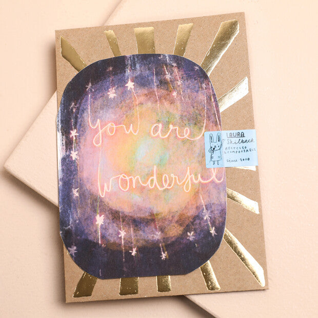 Decorative greeting card with purple galaxy art, gold rays, and “You are wonderful” text