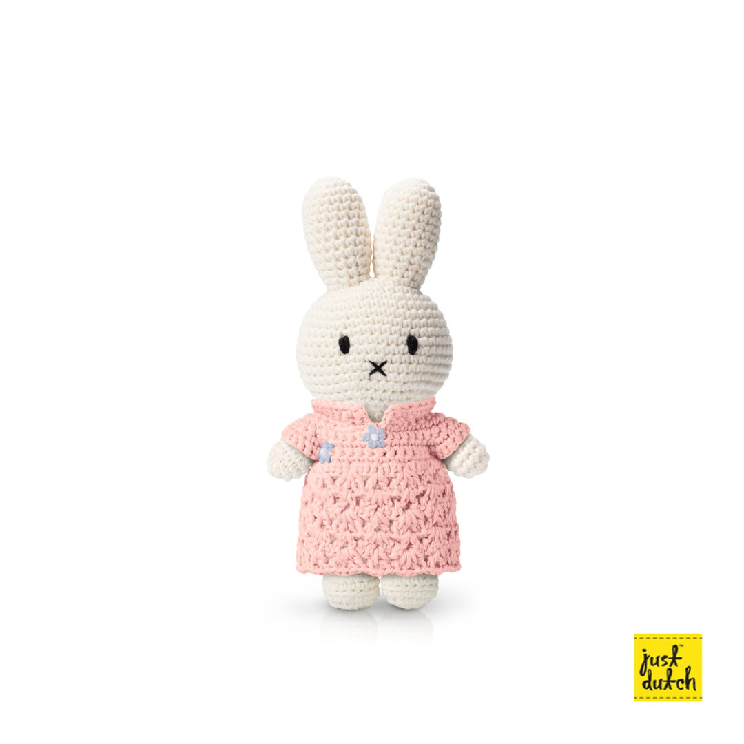 Pink crochet qipao dress with high collar and short sleeves on a rabbit plush