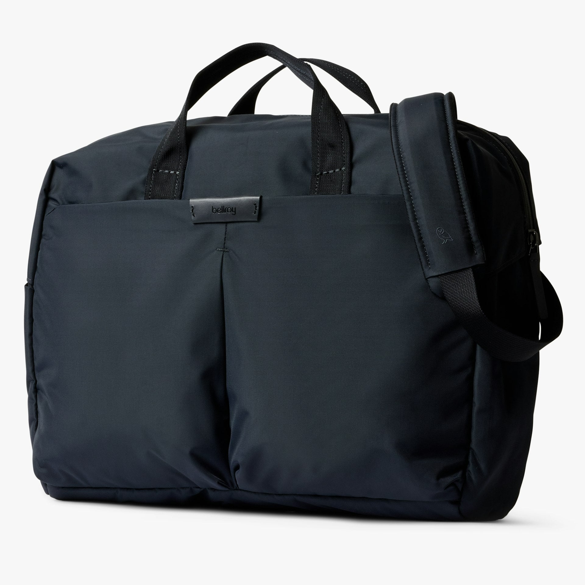 Navy work bag with top handles, front pocket, and attached shoulder strap