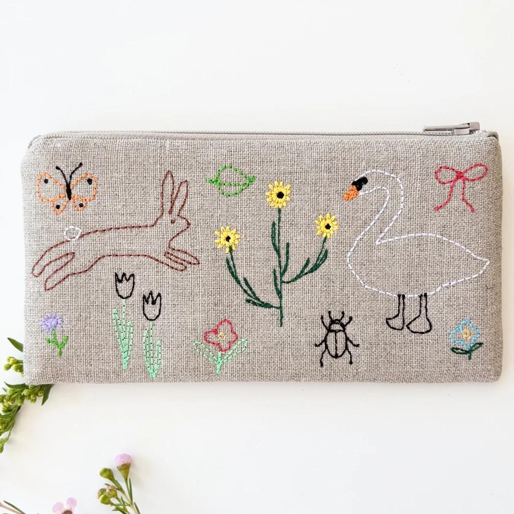 Small linen zipper pouch, beige fabric with colorful cartoon animal embroidery