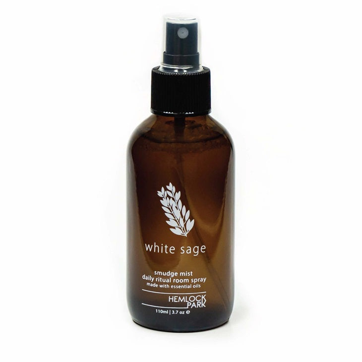 White sage smudge spray in amber bottle with black pump sprayer
