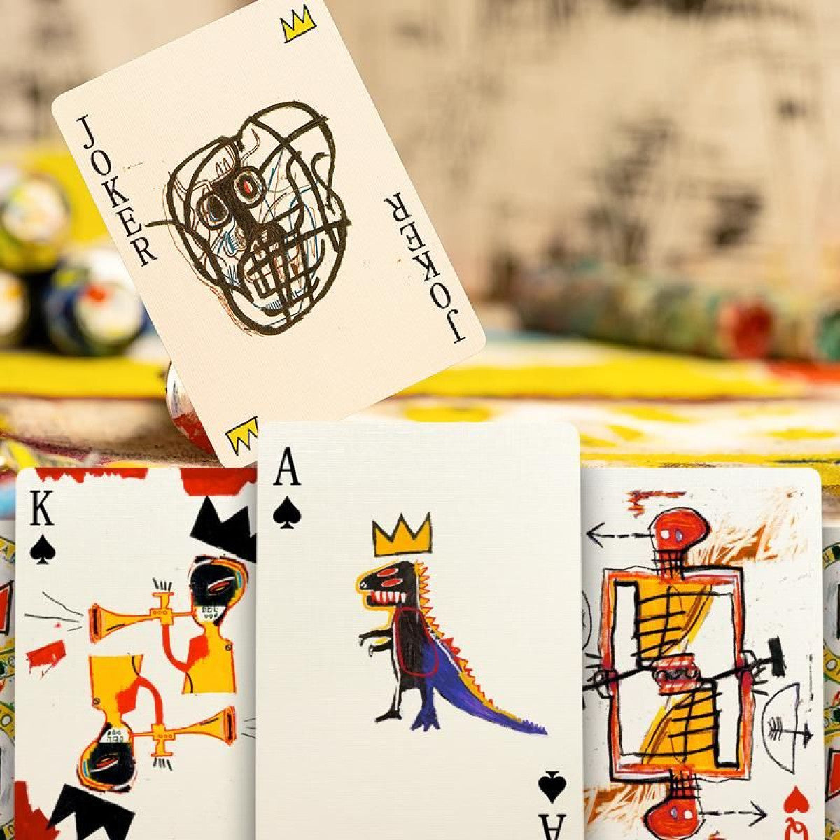 Basquiat playing cards spread with multiple face-up faces, kings and queens