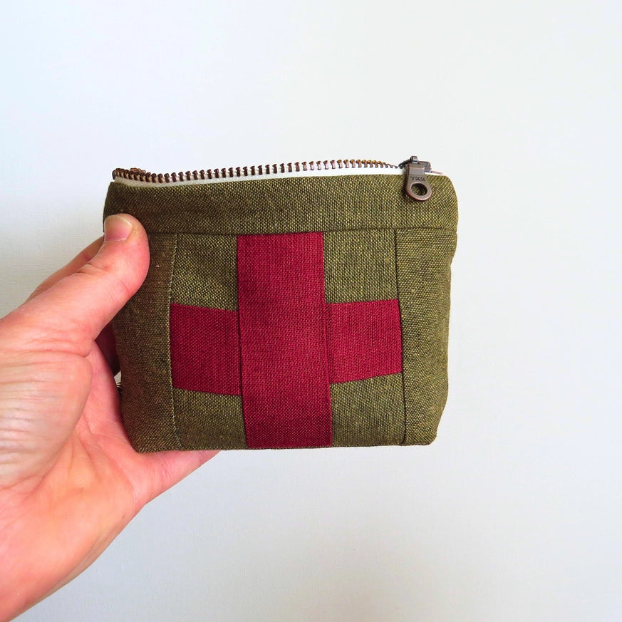 Mini first aid kit pouch in olive fabric with red patchwork cross and top zipper