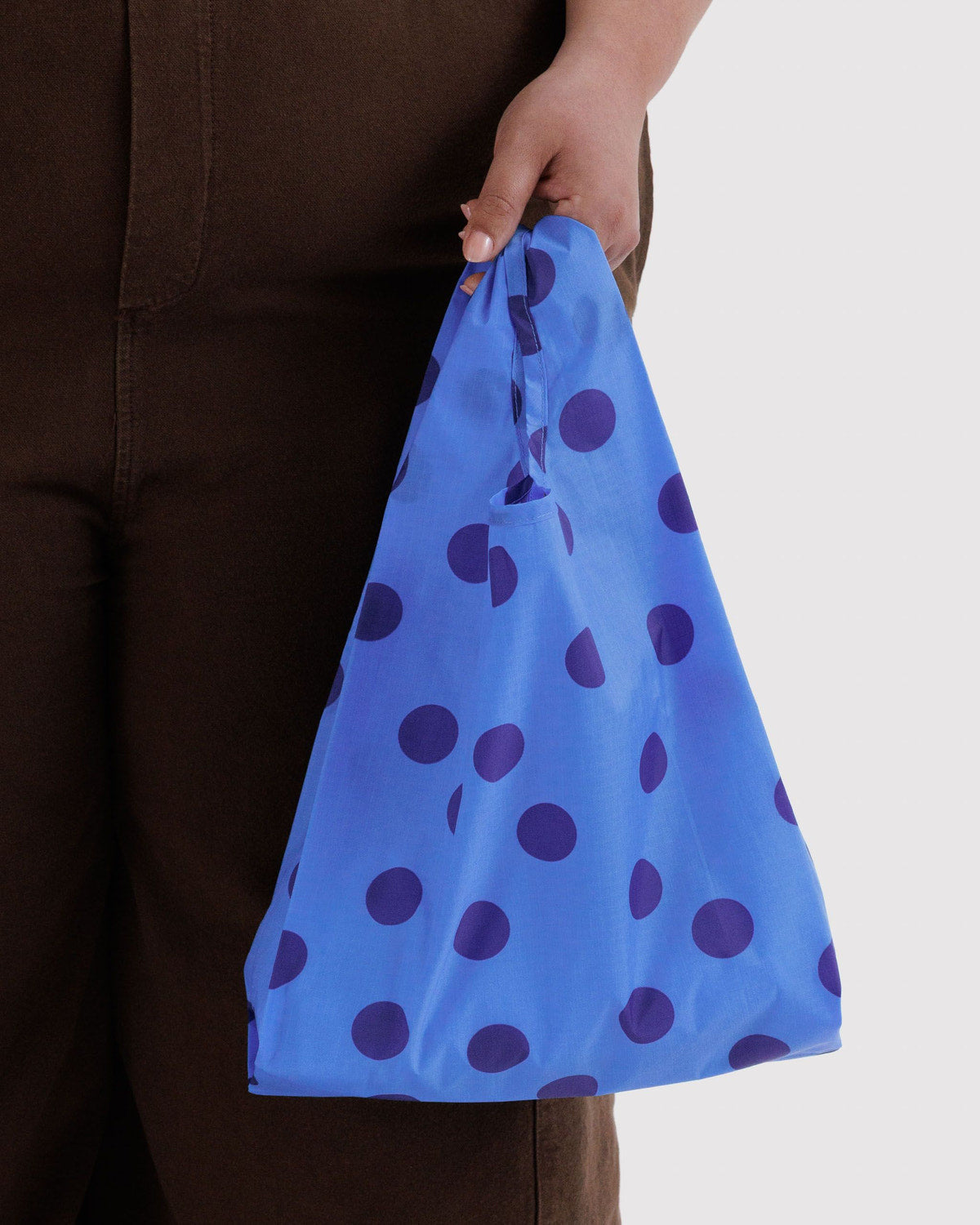 Baggu reusable tote in bright blue with navy dot pattern, gathered top handle