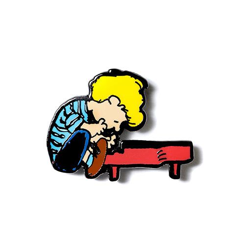 Schroeder Peanuts enamel pin of cartoon boy playing piano, multicolor