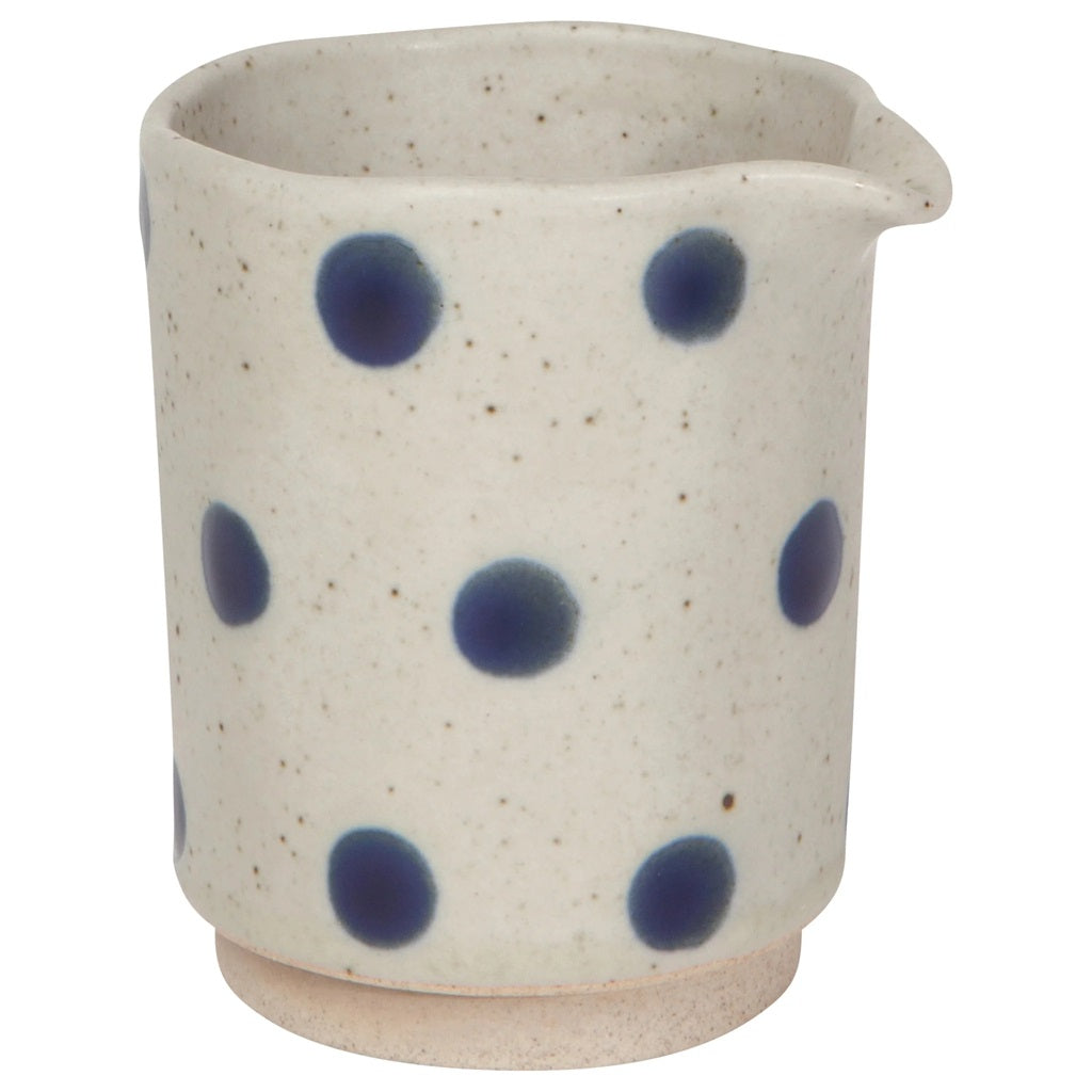 Ceramic cream jug with blue polka dot pattern and speckled beige exterior