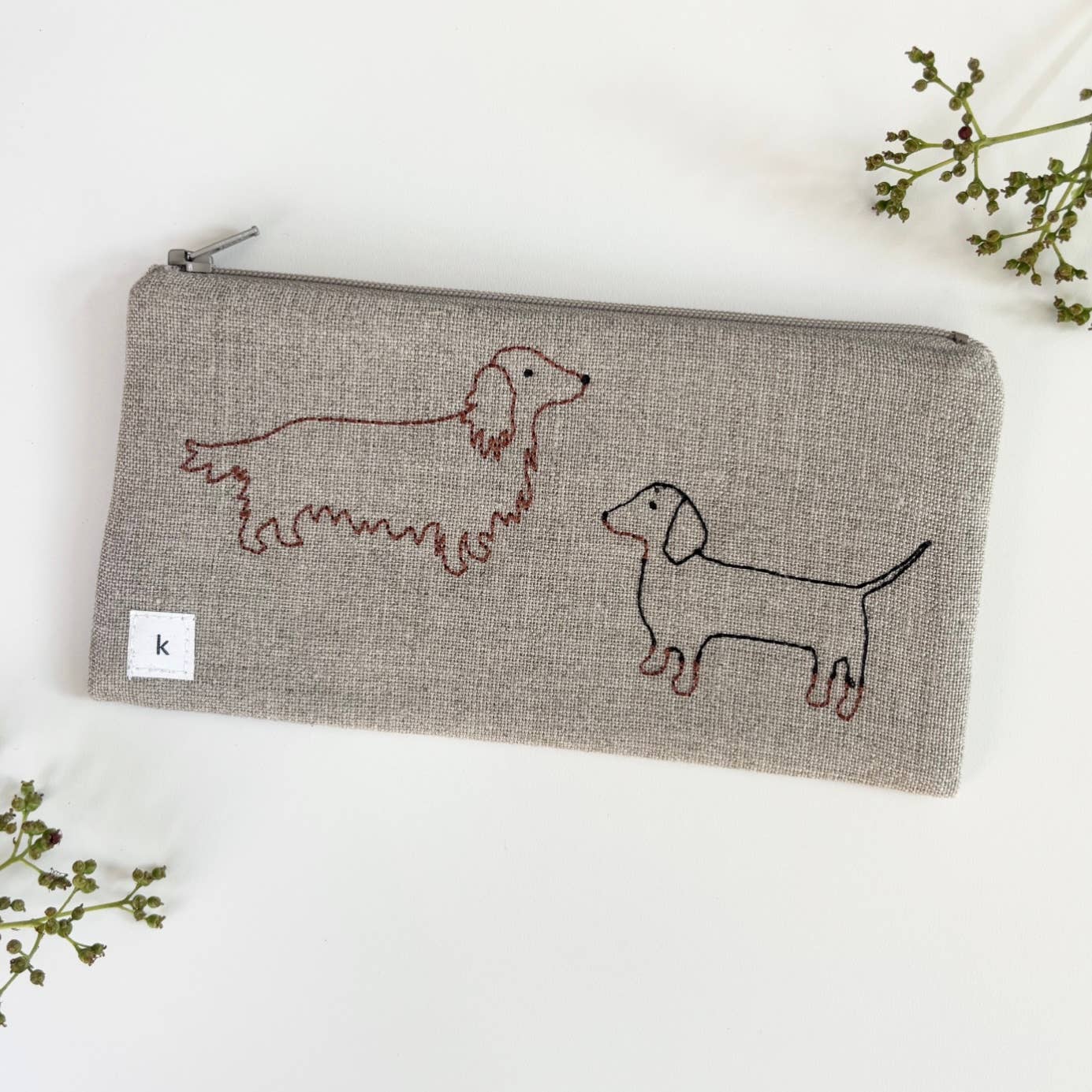 Small linen pouch in heather gray with zipper and red embroidered dachshunds