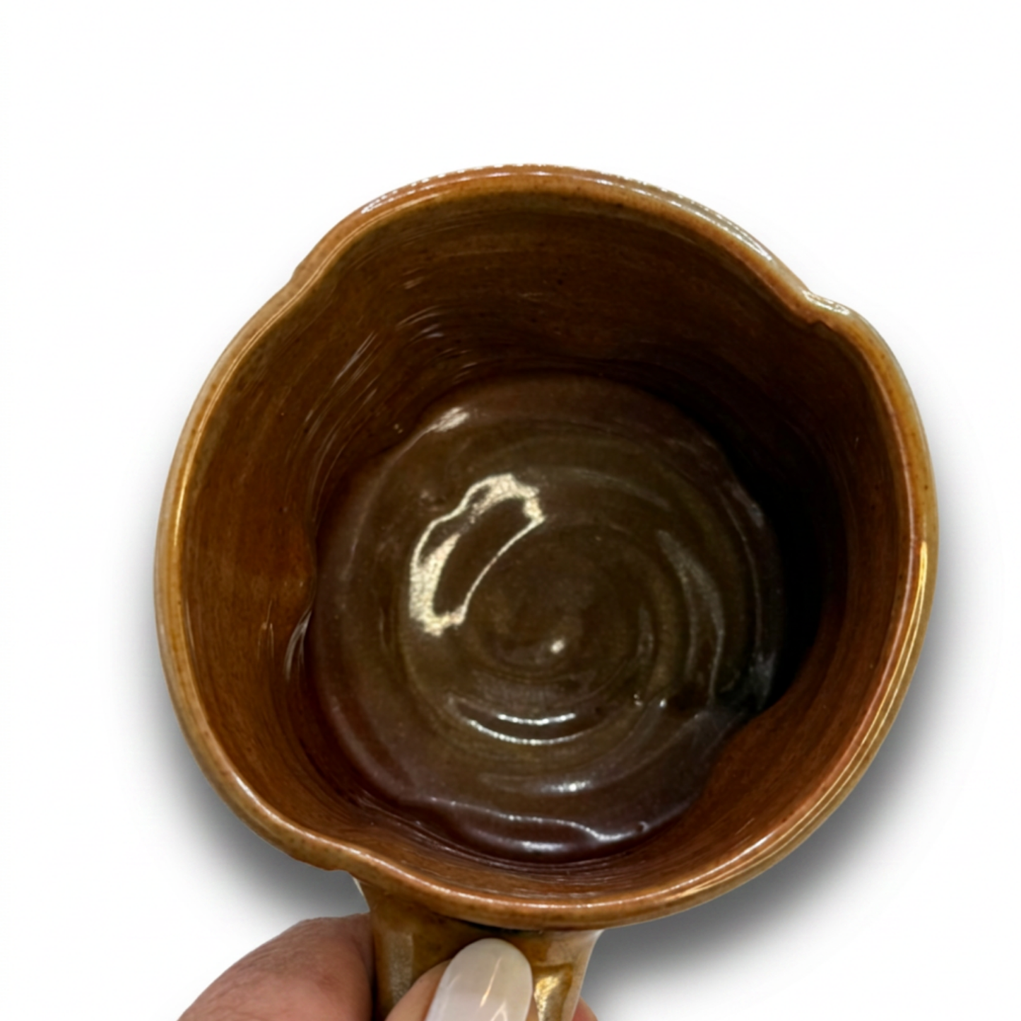 Gloss brown ceramic mug interior with glossy glaze and circular swirl pattern