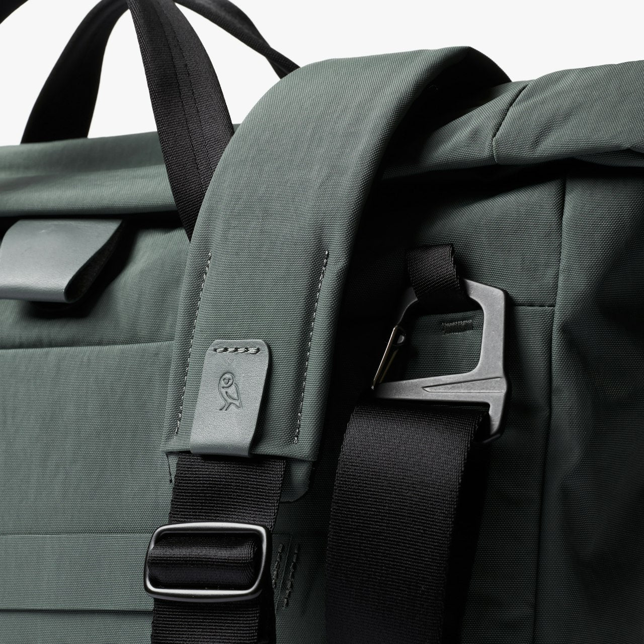 Everglade green messenger bag with front detail patch and adjustable strap hardware.