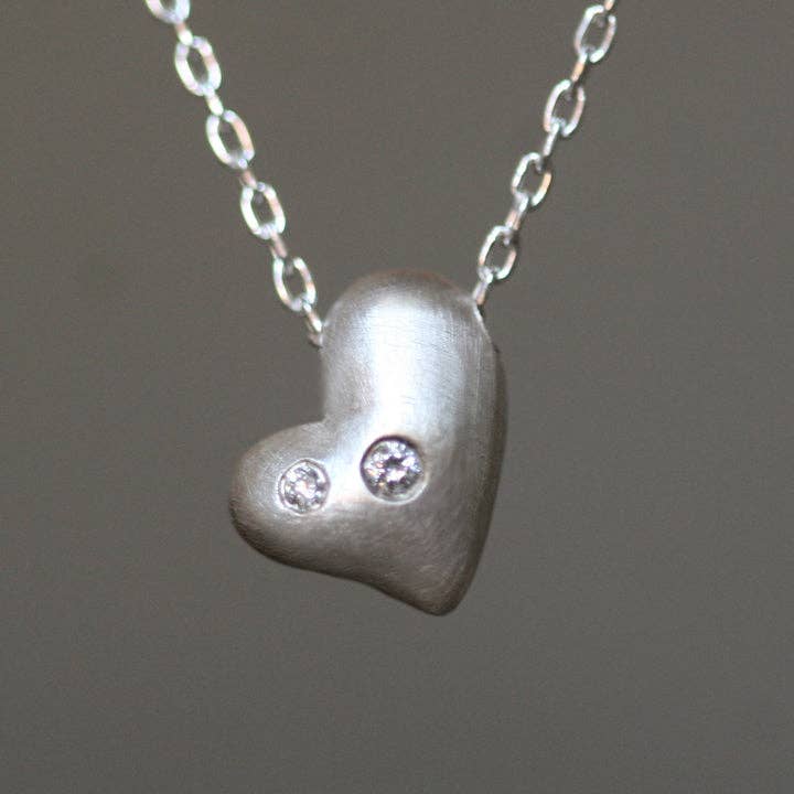 Sterling silver heart pendant necklace with three round diamond accents