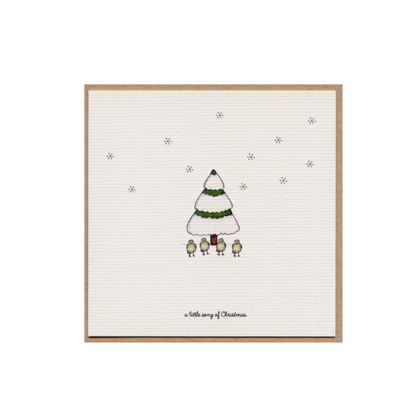 Christmas card with a small illustrated green tree and star dots on cream paper
