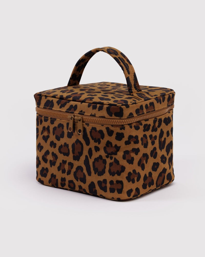 Large cosmetic case in leopard print with top handle and zip closure.