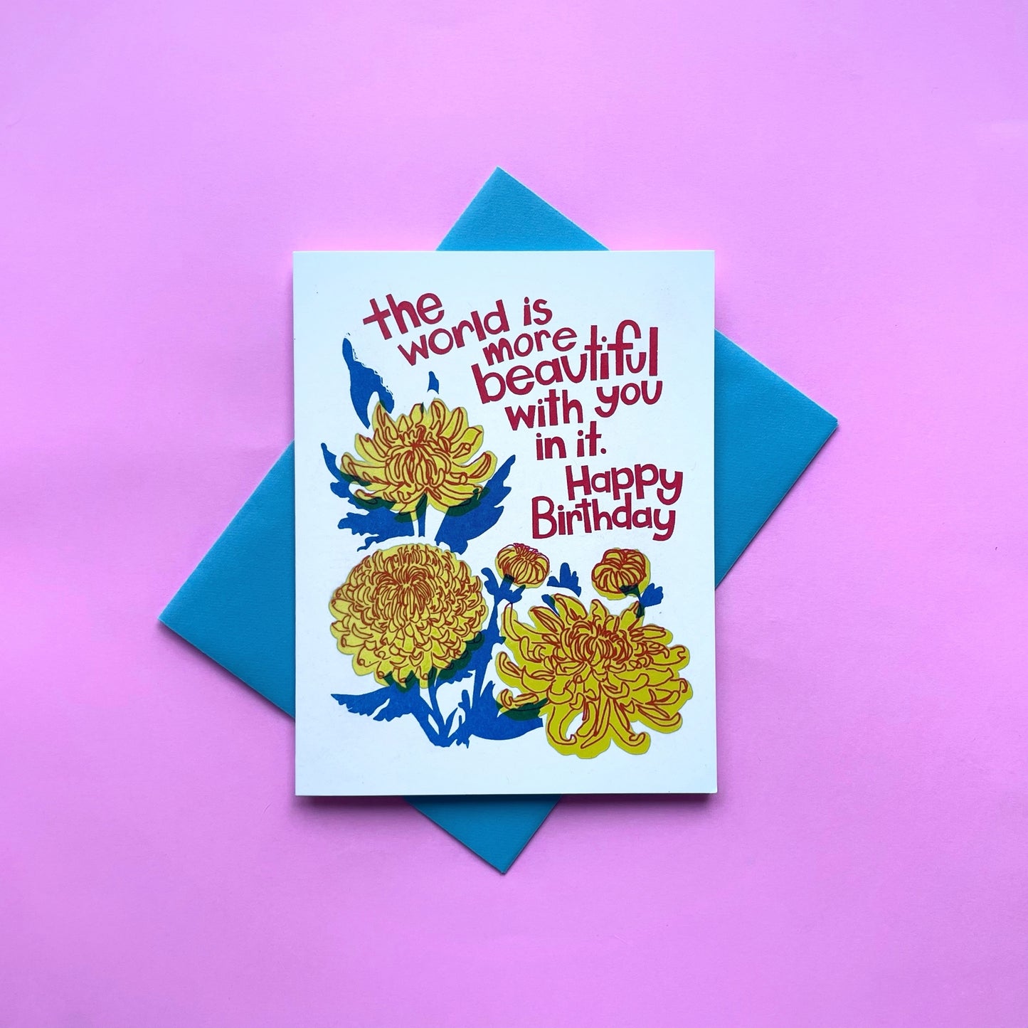 Birthday greeting card with blue letterpress text and yellow mum flower illustration