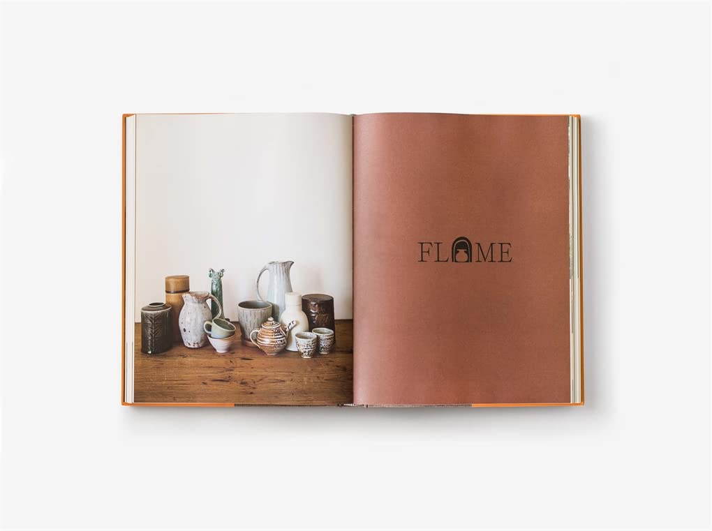 Open ceramics book with photo of pottery tools and warm orange page edge