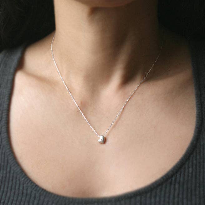 Sterling silver heart necklace on a chain with small diamond-set heart