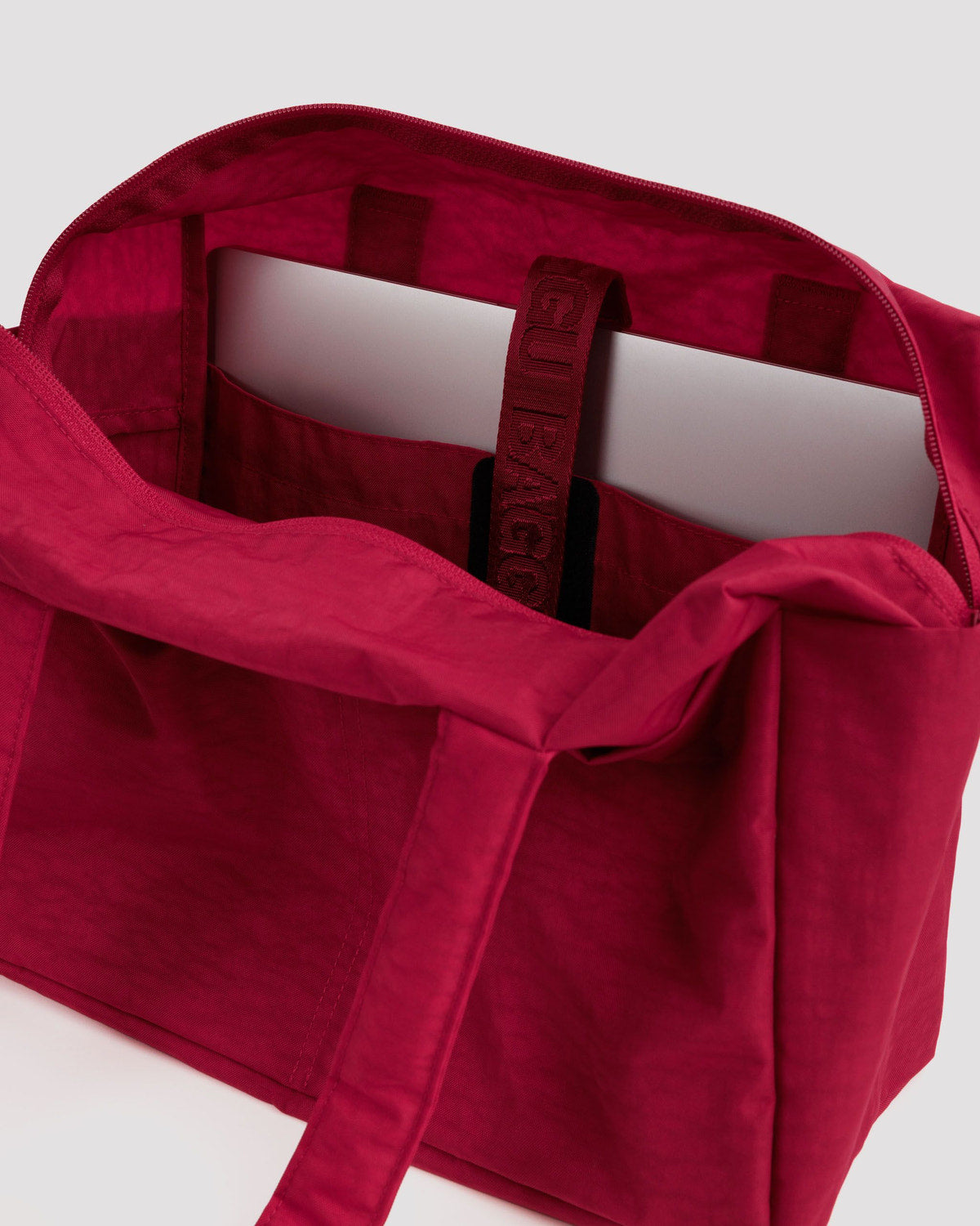 Red cloud tote bag interior view with open top and hanging label