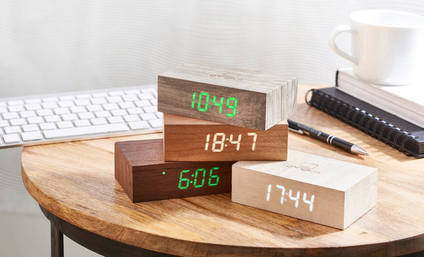 Multiple Flip Click Clock blocks with green and white LED time displays on a desk