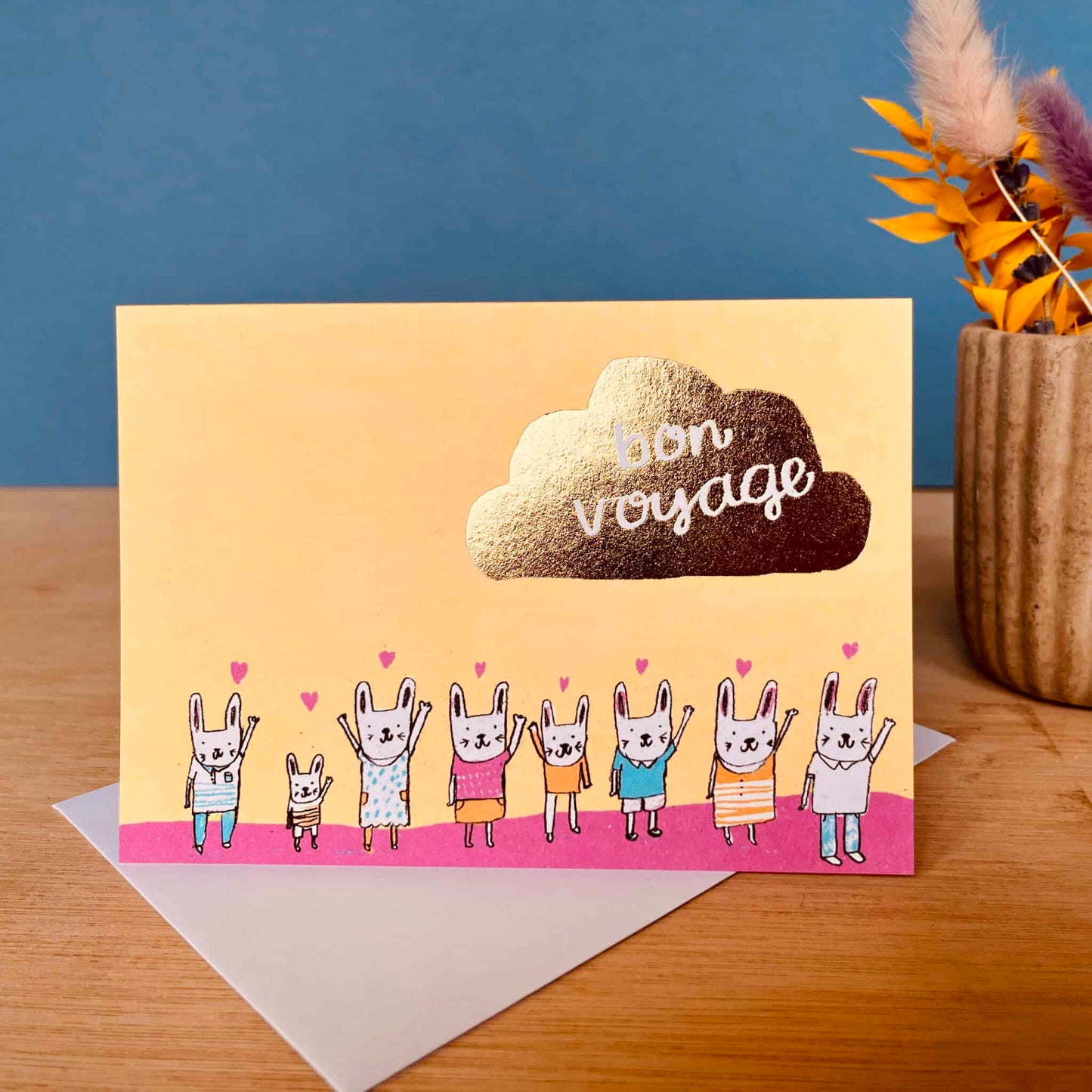 Bon Voyage gold bunnies greeting card with cloud text and five bunny characters