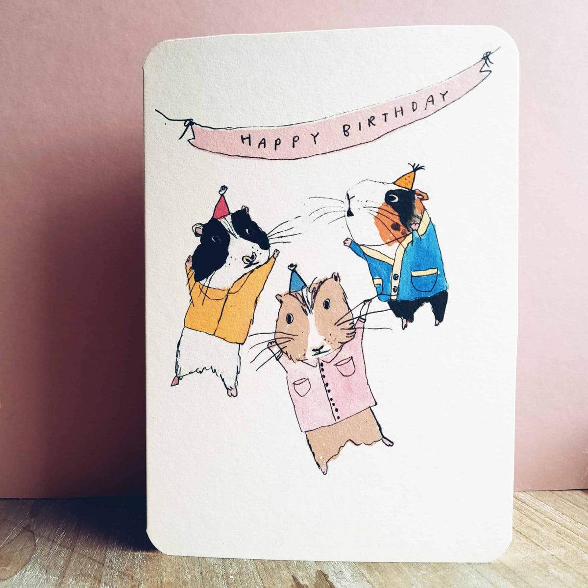 Birthday guinea pig party card with illustrated guinea pigs and “HAPPY BIRTHDAY” banner