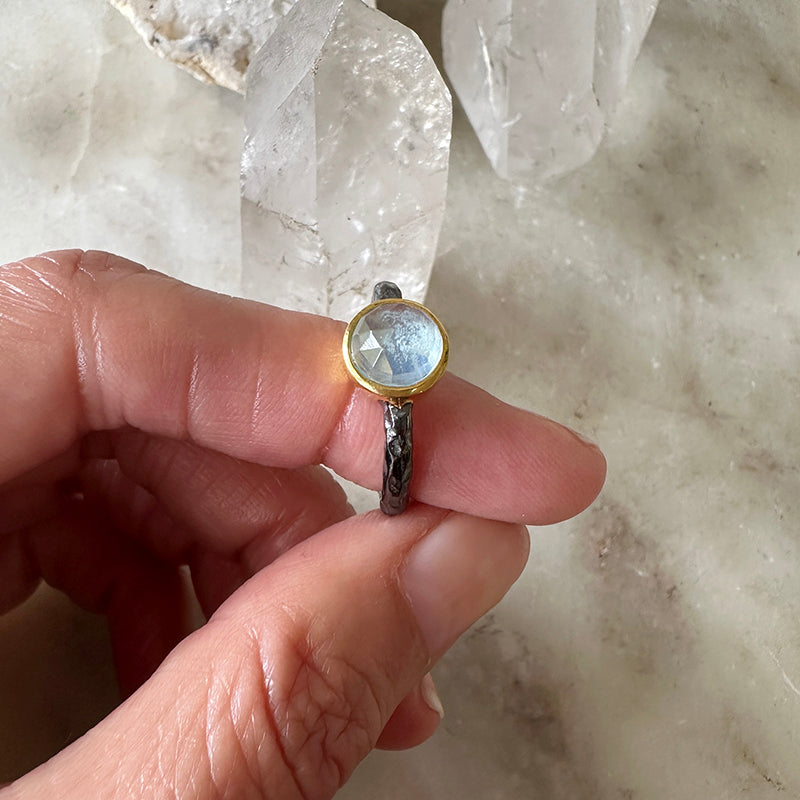 Oxidized sterling silver ring with oval aquamarine cabochon and gold vermeil bezel