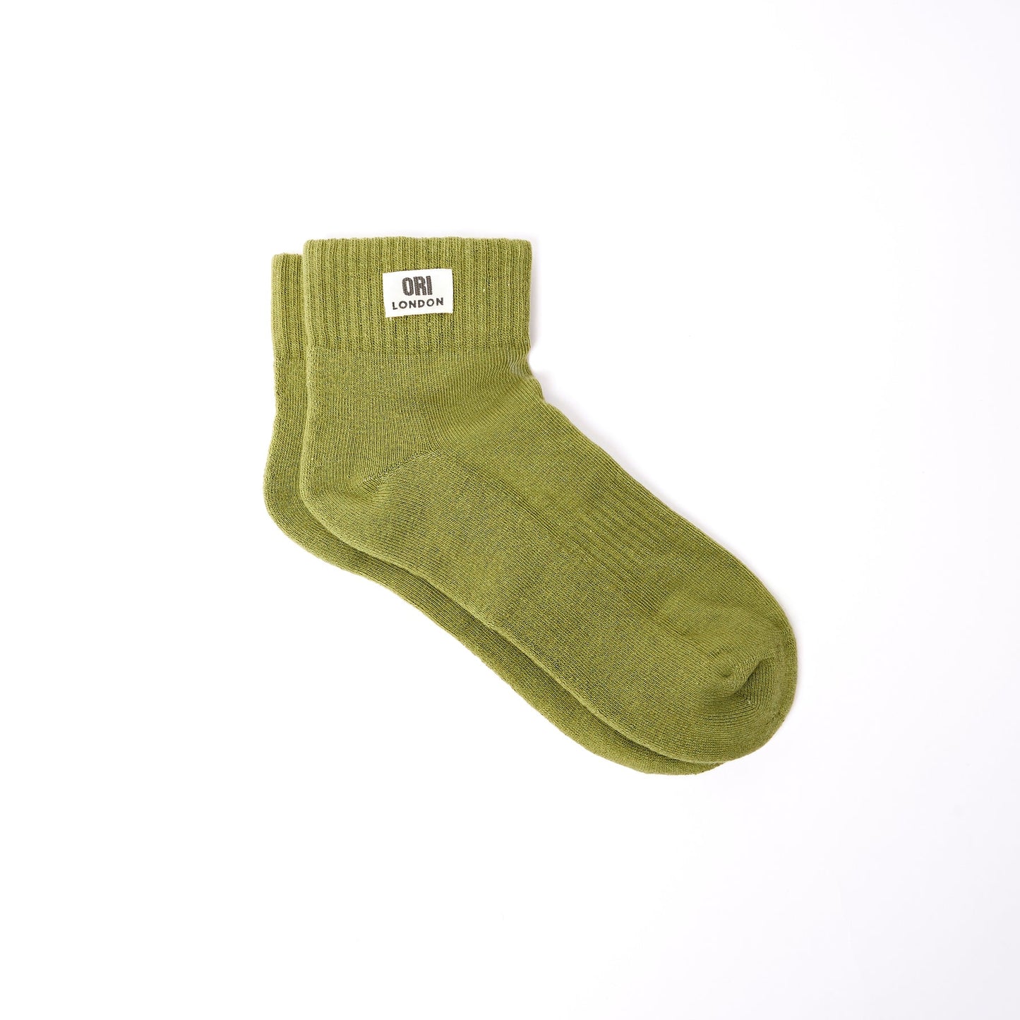 Men's ankle socks in avocado green with ORI LONDON logo patch at cuff.
