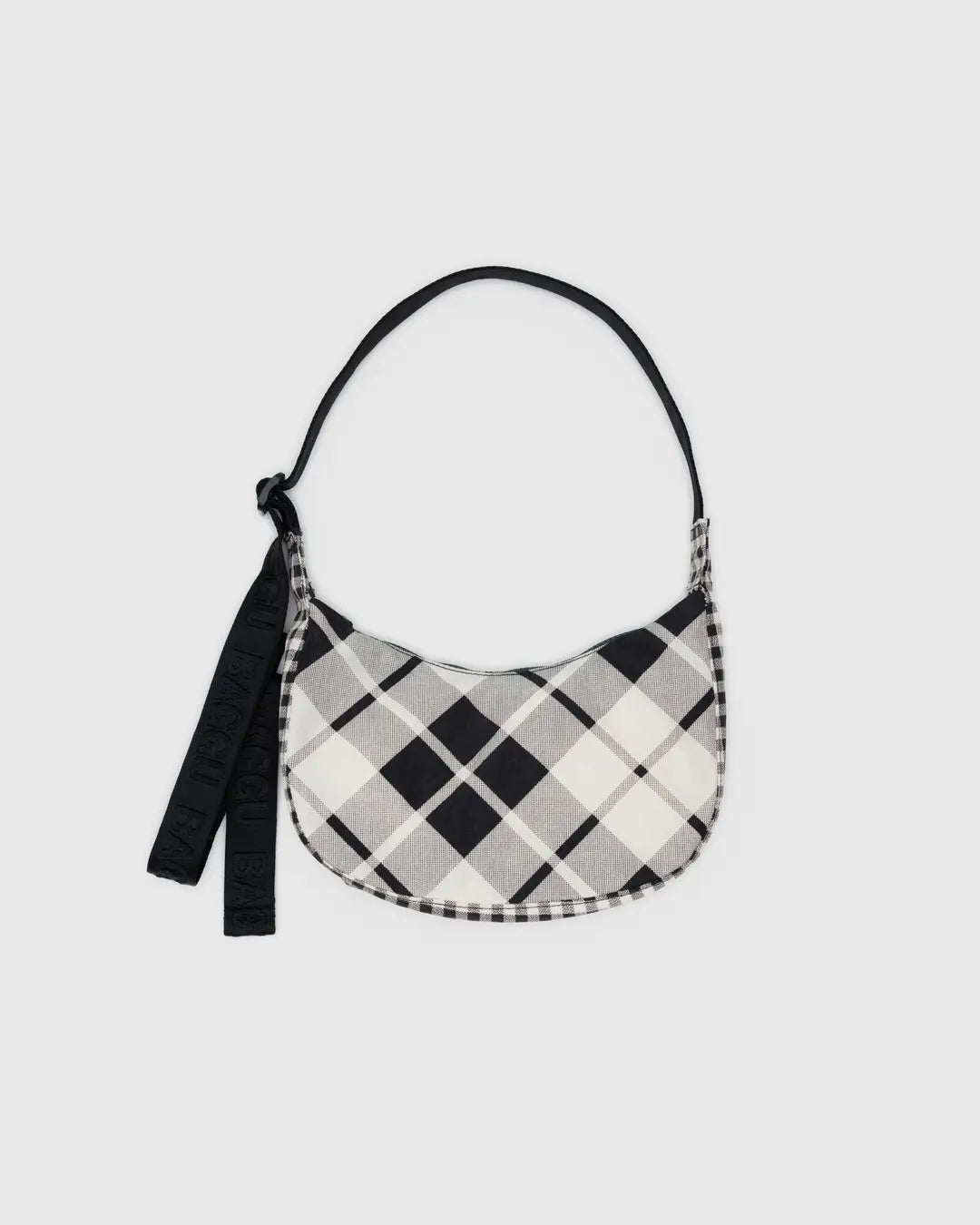 Small crescent nylon crossbody bag with black and white plaid body and hanging tag