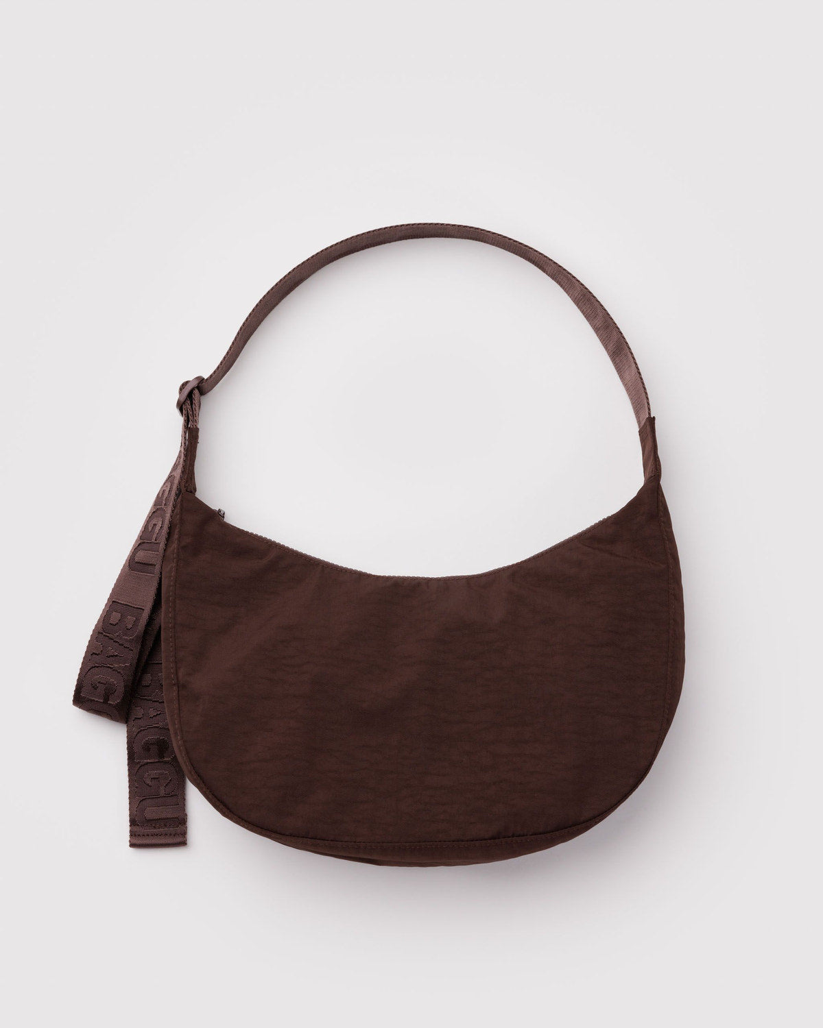 Brown nylon crescent bag with adjustable strap and hanging tag