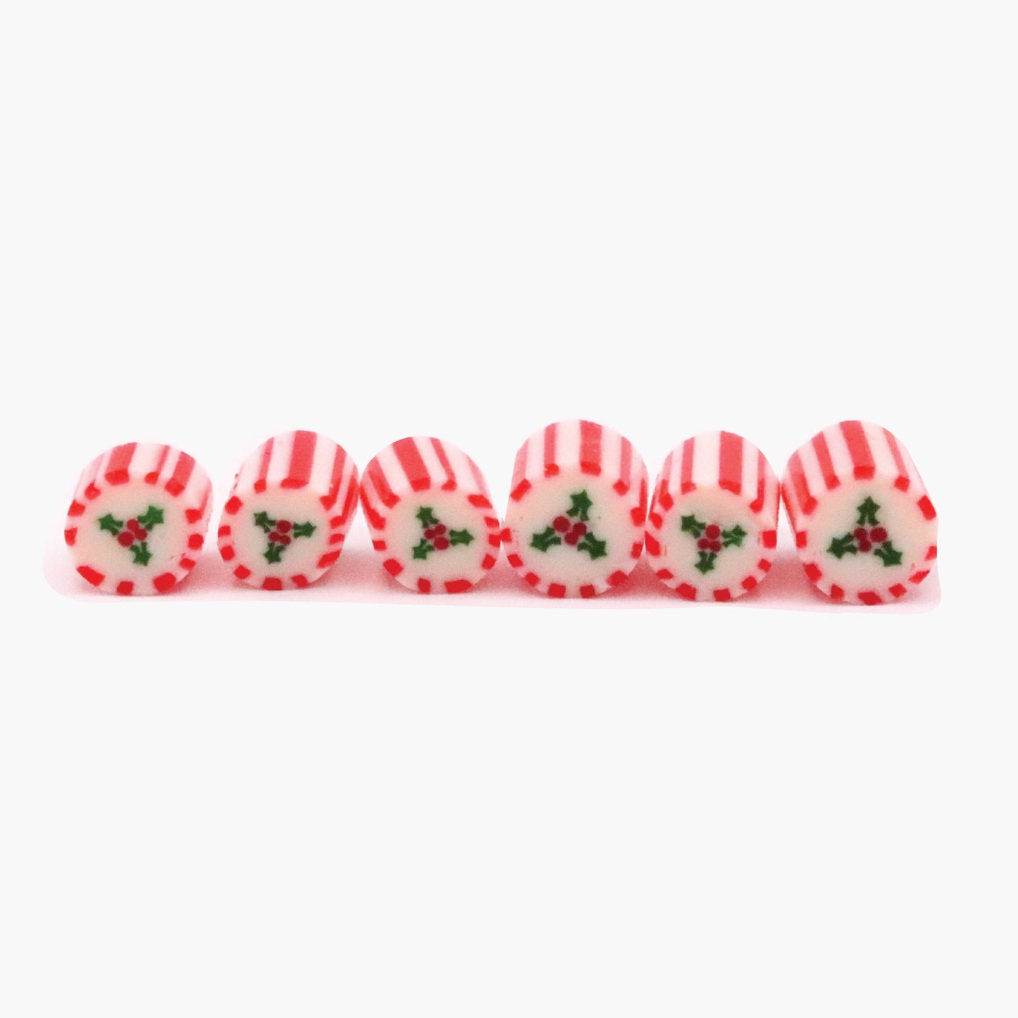 Striped red-and-white peppermint candies with green holly pattern