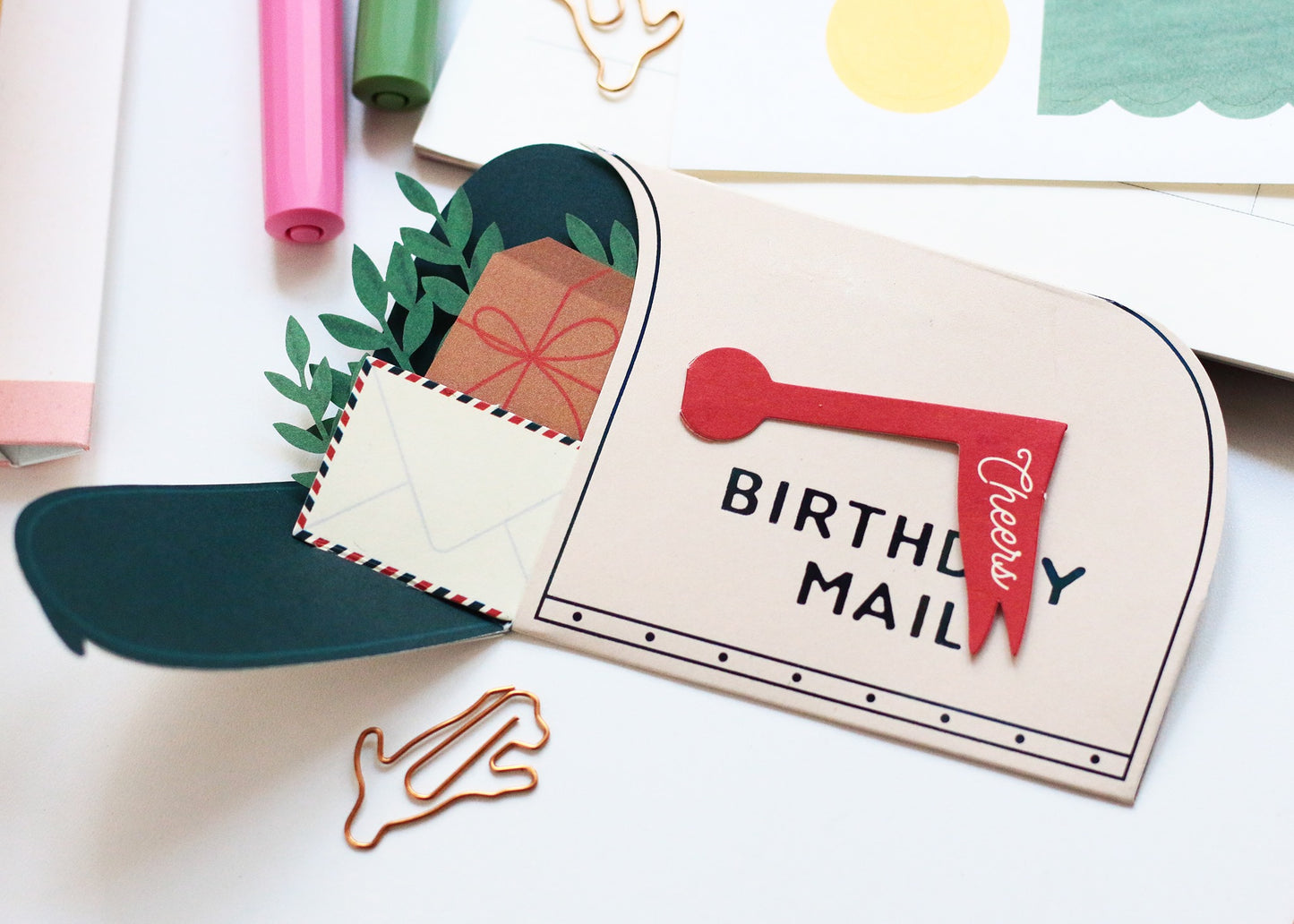 Birthday mail pop-up card close-up with red handle, BIRTHDAY MAIL text and kraft envelope