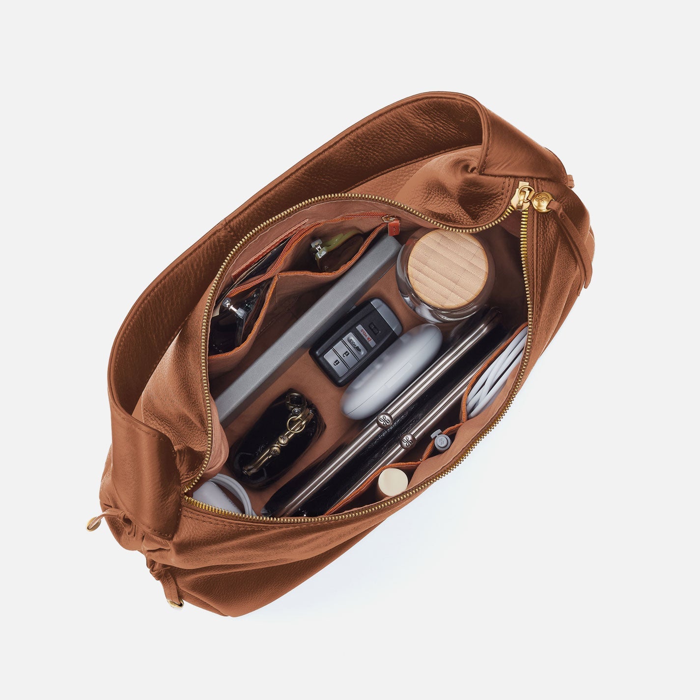 Warm honey hobo bag open view showing interior zip pocket and accessories
