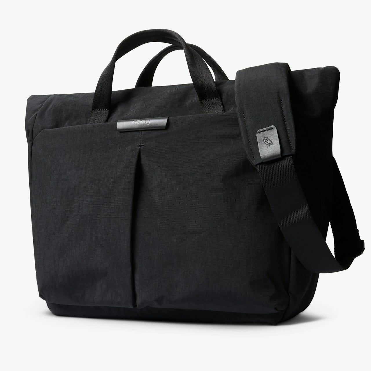 Black messenger bag with top handle, side pocket, and adjustable crossbody strap.