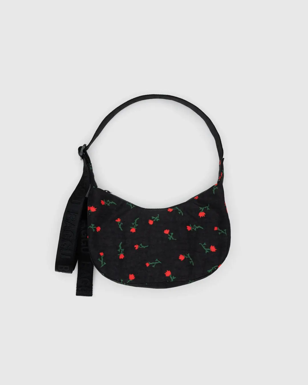 Small crescent nylon crossbody bag in black with red floral print and hanging tag