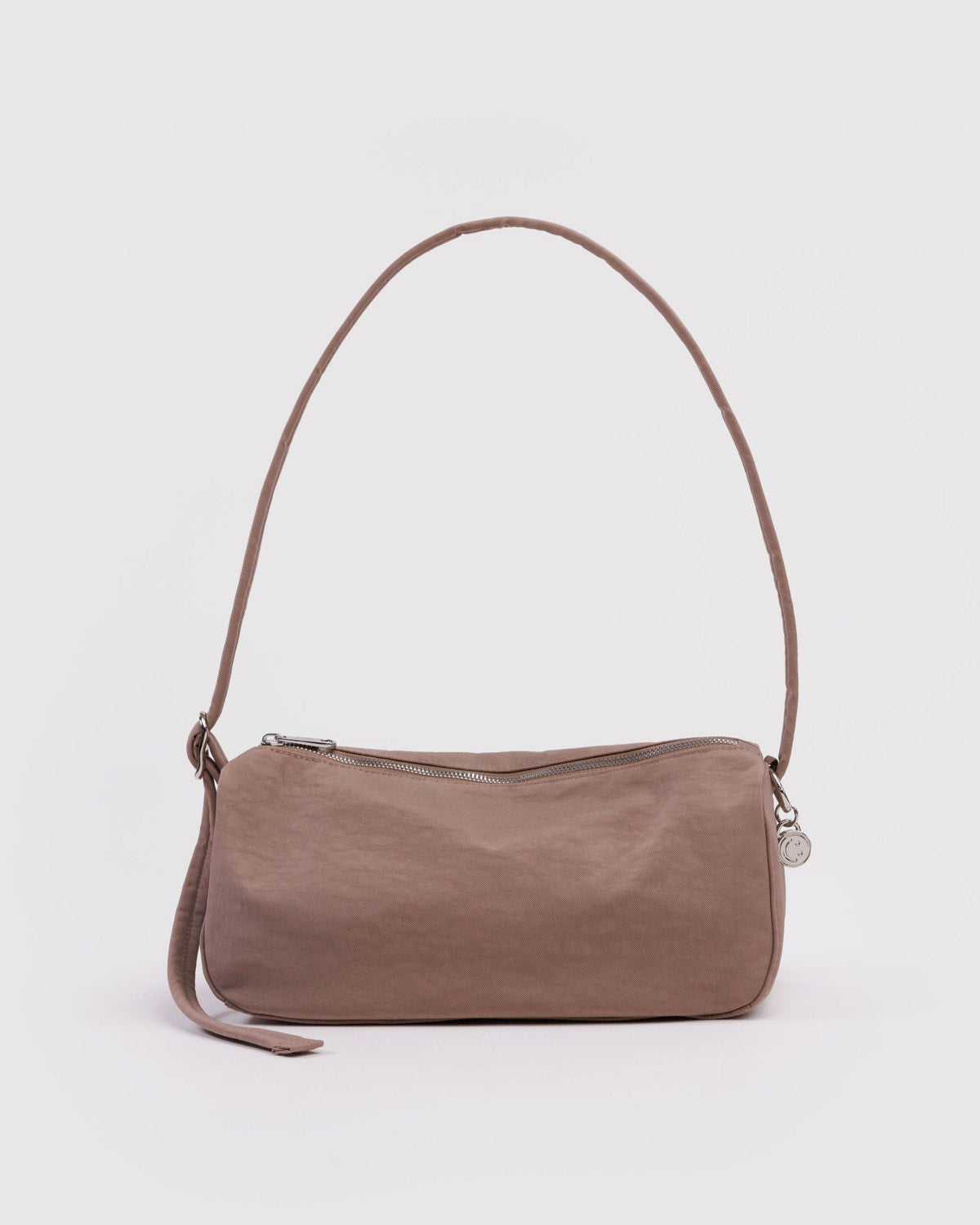 Toasted almond nylon loaf bag with curved top handle, side strap, and top zipper.