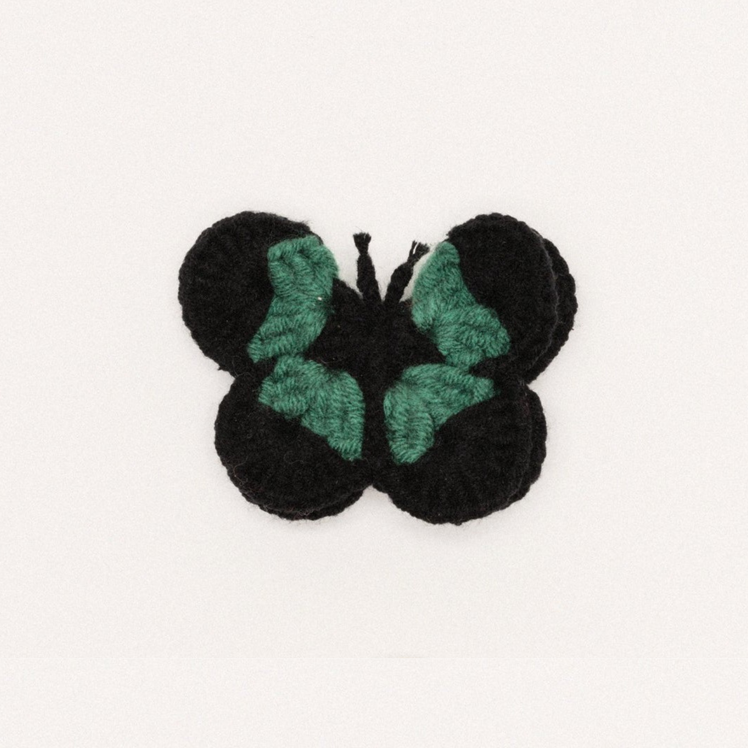 Black crochet butterfly hair clip with teal wing details