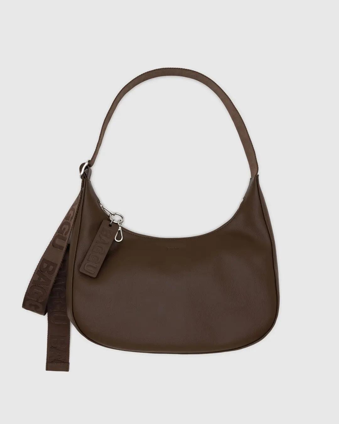 Medium recycled leather crescent bag in brown, zip top, shoulder strap with tassel