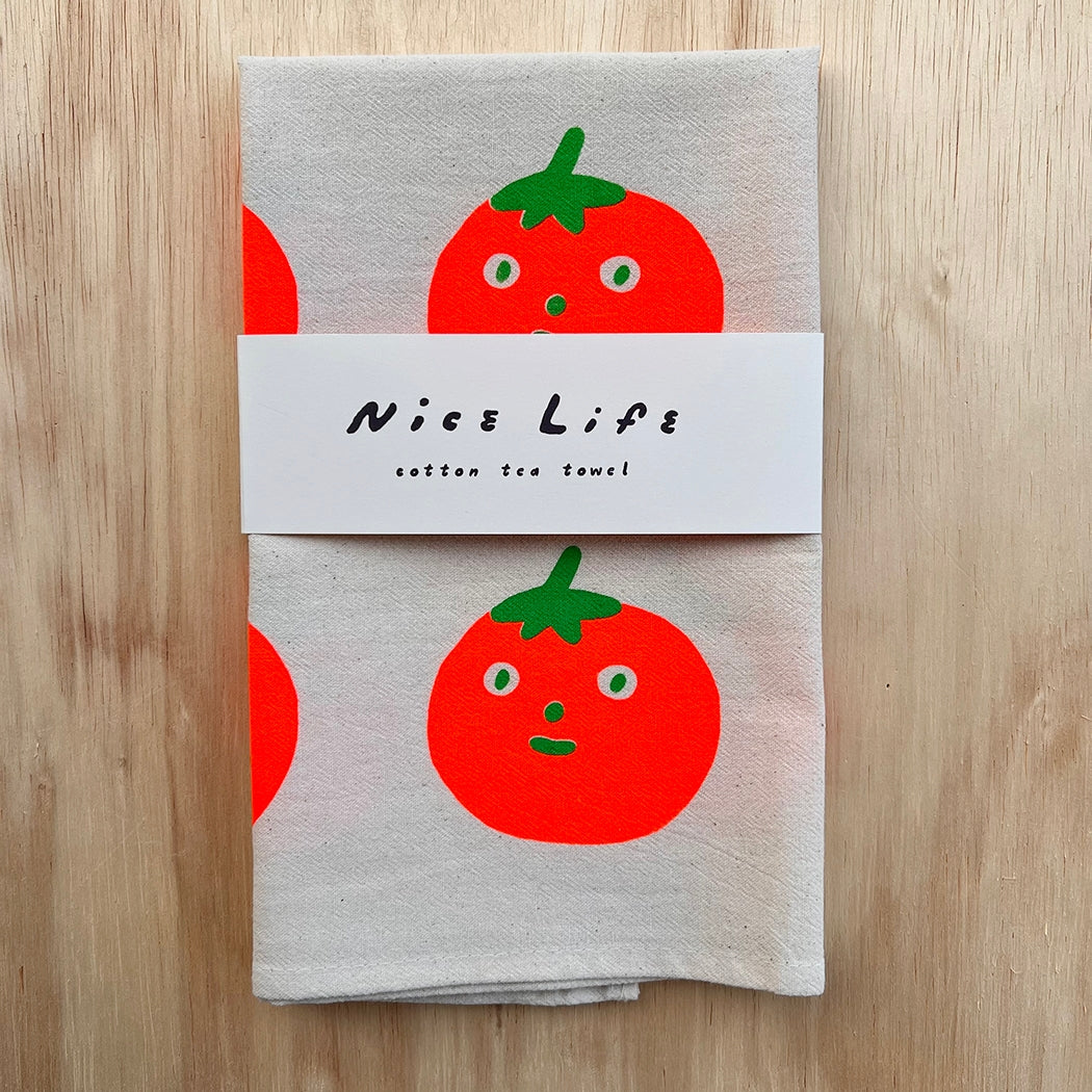 Gray cotton tea towel bundled with a white label and red tomato face print