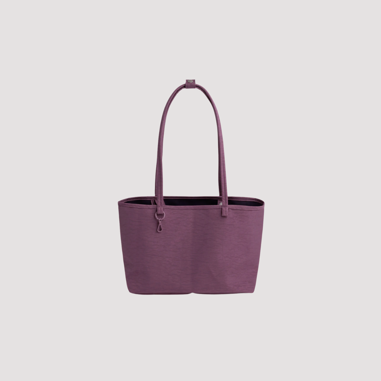 Medium reversible nylon tote with top handles and zip closure, wild plum purple.