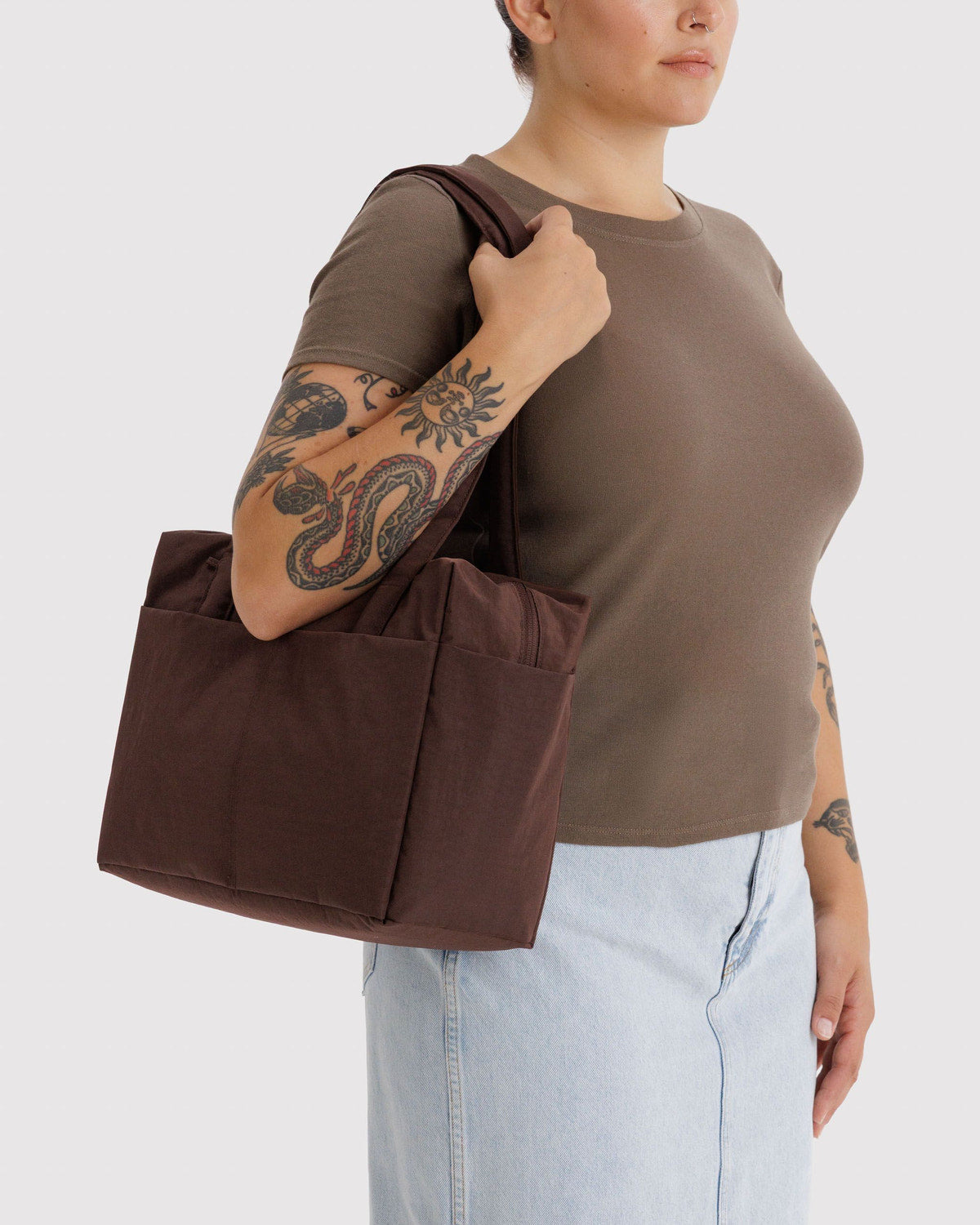 Brown canvas tote bag with wide handles and front pocket