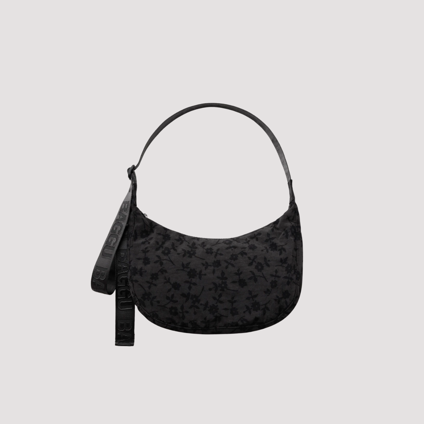 Medium nylon crescent bag in black with printed fabric, top handle, and zipper