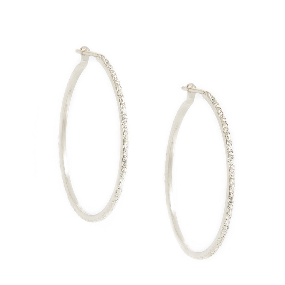 Medium round sterling silver hoop earrings with diamond-dusted texture