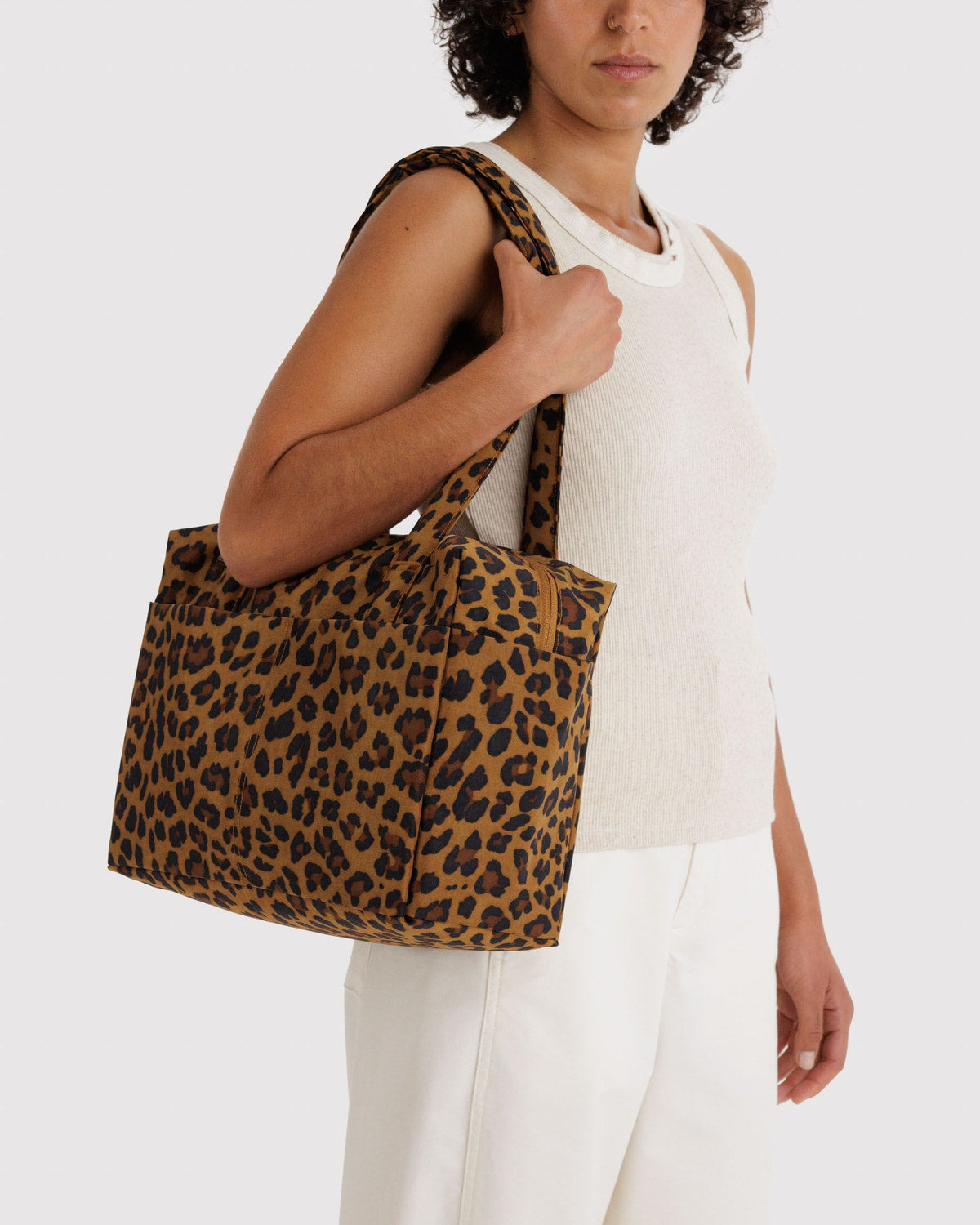 Leopard-print cloud tote bag carried on shoulder, two top handles